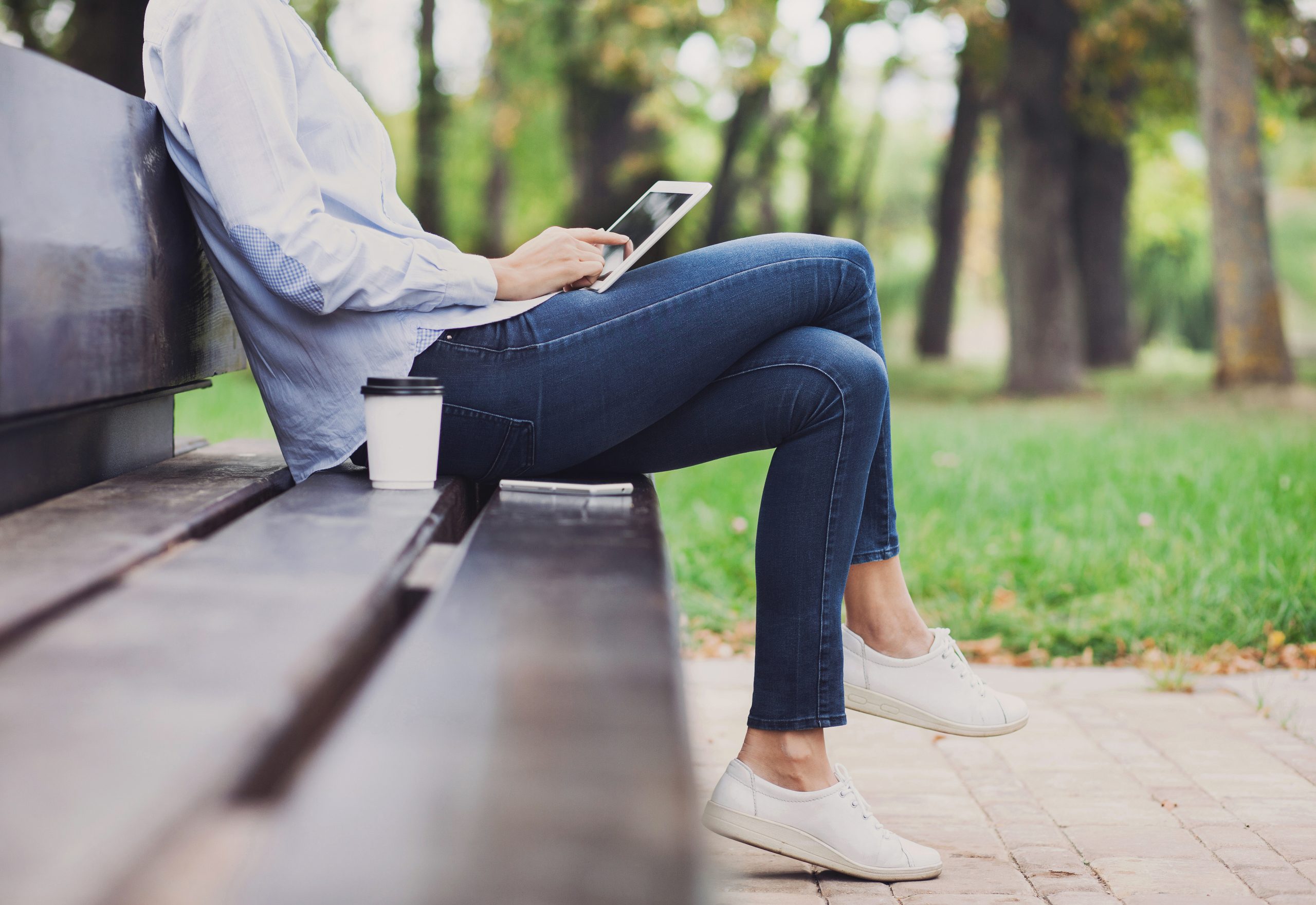 Young woman using digital tablet outdoors