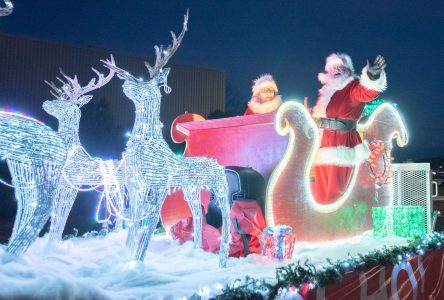 Santa greeted by fans during Christmas Parade of Lights